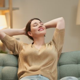 Portrait of beautiful woman resting on sofa at home